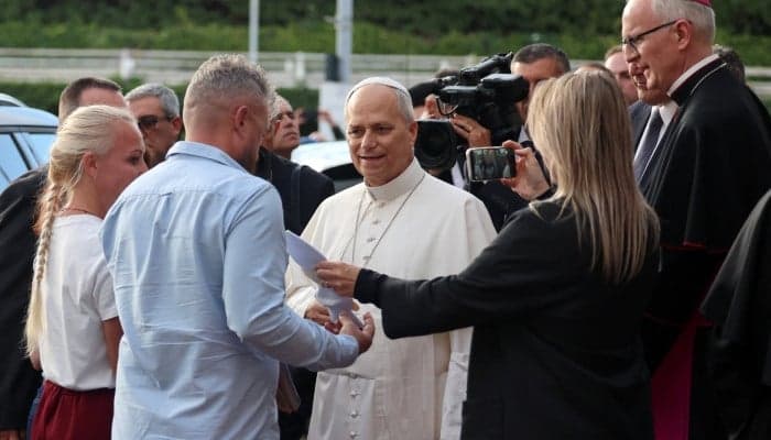 Pope Leo speaks to a Ukrainian family whose daughter is undergoing cancer treatment, as he leaves Gemelli hospital following lung surgery and cancer diagnosis, in Rome, Italy, October 17, 2026.