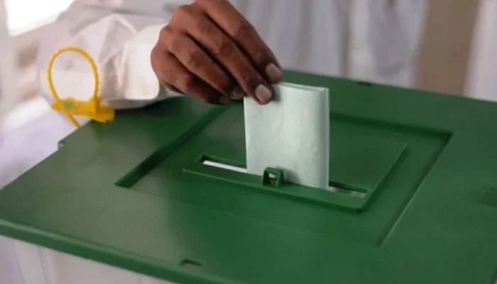 FILE – This undated image shows a man casting vote in ballot box.