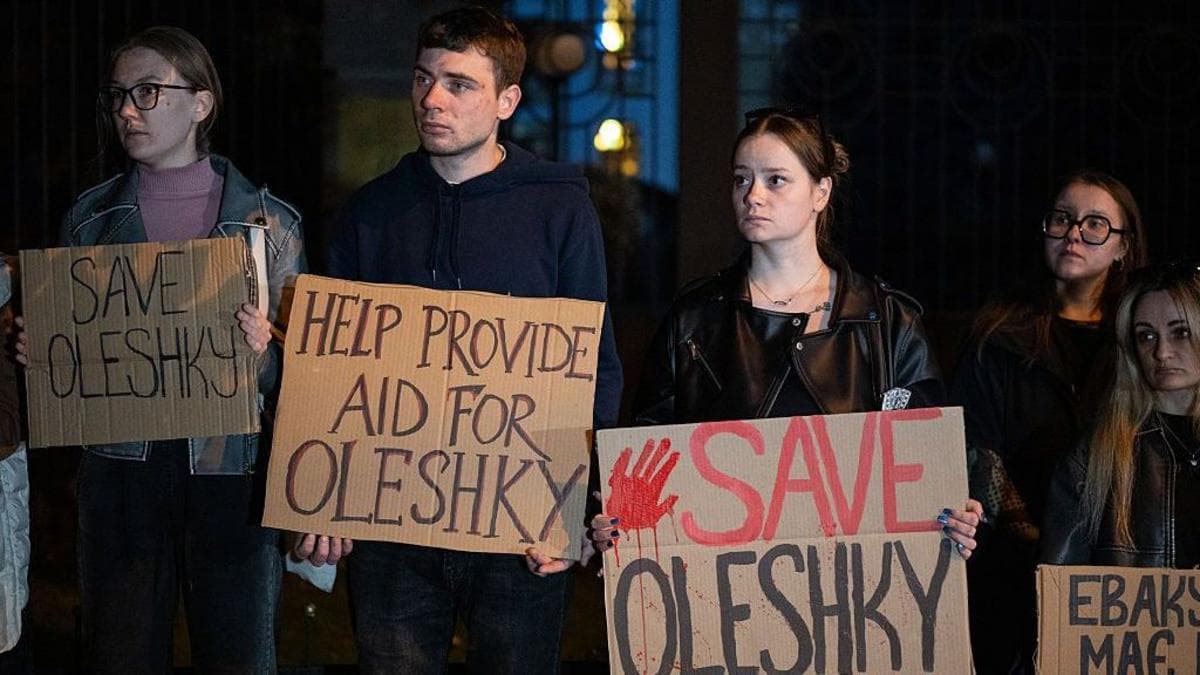Activists hold placards with slogans during a rally in support of residents of Oleshky, Kherson region, calling on the international community to draw attention to the humanitarian situation in the Russian-occupied city.